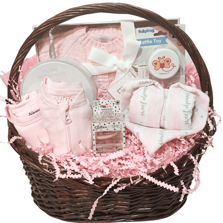 Baby Essentials Premium gift basket in pink, unwrapped, featuring baby bath items, blanket and grooming accessories arranged in a keepsake basket