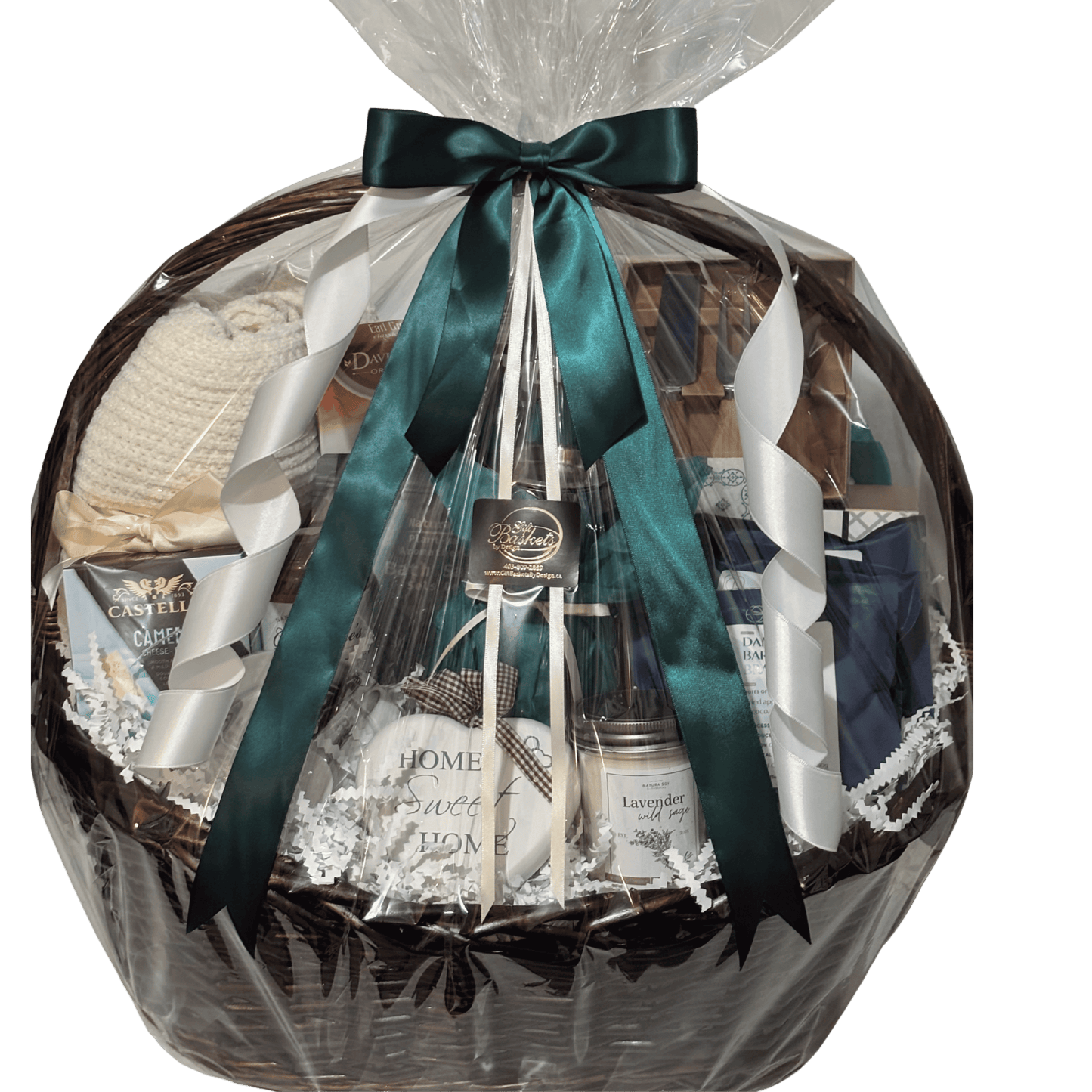 Cozy Home Collection housewarming gift basket with a plush blanket, gourmet treats, coffee, tea, brie baker and candle, wrapped with a teal bow.