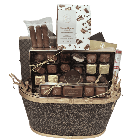 An elegant chocolate gift basket filled with premium boxed chocolates, gourmet truffles, chocolate wafers, buttery shortbread, handcrafted fudge, almond butter crunch, beautifully displaying contents unwrapped.