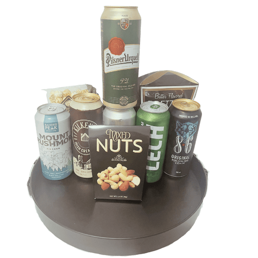 Beer gift basket with six international beers, pretzels, nuts, chips, and gourmet snacks, unwrapped and arranged for delivery in Calgary