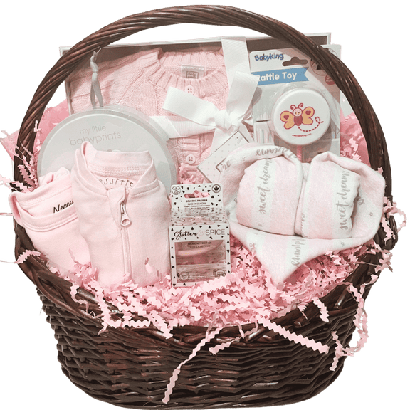 Baby Essentials Premium gift basket in pink, unwrapped, featuring baby bath items, blanket and grooming accessories arranged in a keepsake basket
