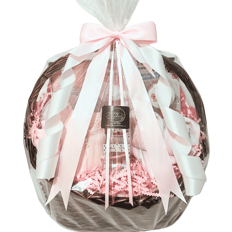 Baby Essentials Premium gift basket in pink, wrapped in cellophane with ribbon, featuring baby bath items, blanket and grooming accessories ready for Calgary delivery.