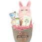 Pink Bunny Baby Gift Basket contents - washcloth mitt, washcloths, biodegradable wipes, rattle toy, baby body wash, and baby butter
