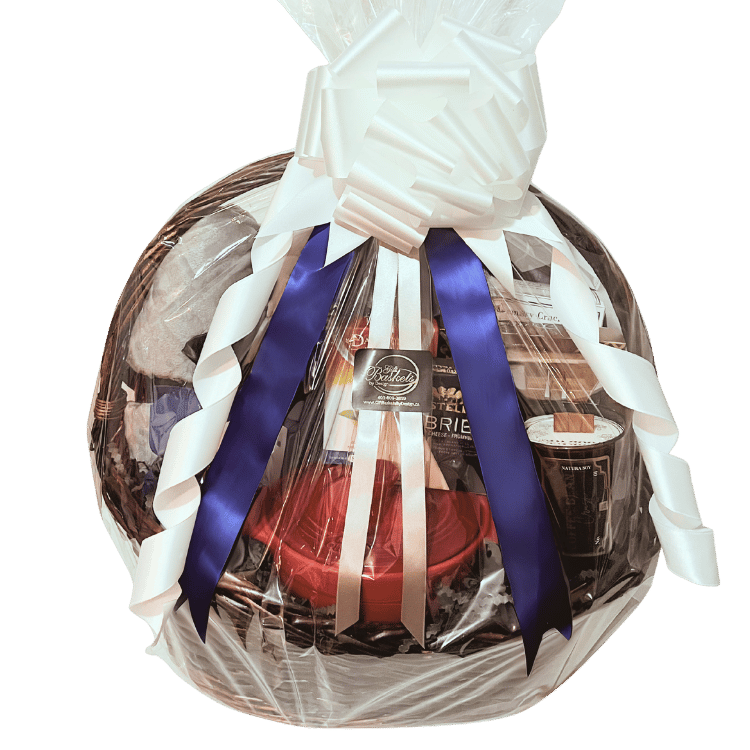 Cozy housewarming gift basket with plush throw blanket, candle, coffee, tea, ceramic brie baker, cheese, and gourmet snacks