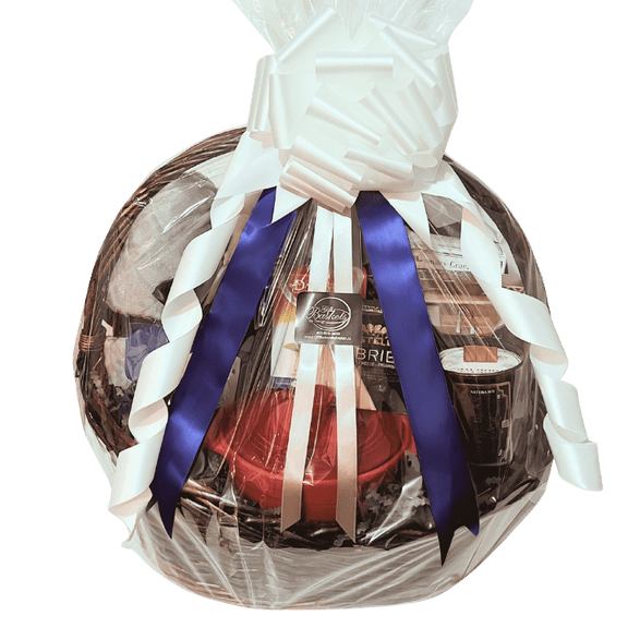 Cozy housewarming gift basket with plush throw blanket, candle, coffee, tea, ceramic brie baker, cheese, and gourmet snacks