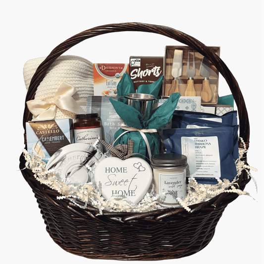 Cozy Home Collection housewarming gift basket with a plush blanket, gourmet treats, coffee, tea, brie baker and candle.
