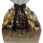 Luxurious gift crate dressed with black ribbons and bows, featuring a gold accent. The wooden cedar crate is labeled 'Vintage,' adding an elegant touch to the presentation