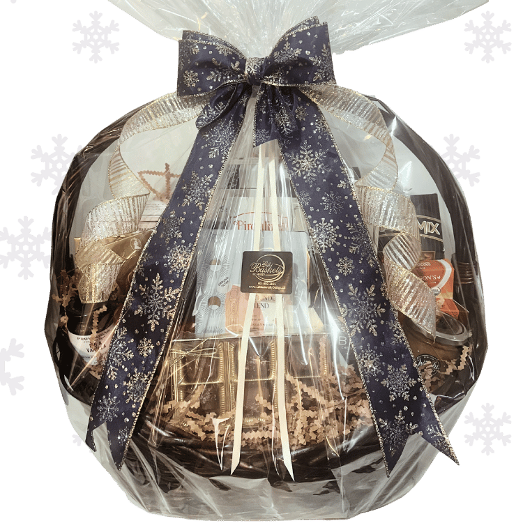 Premium Holiday Gift basket with sweet and savoury treats on a transparent background wrapped in cellophane and sparkly festive snowflake ribbon.