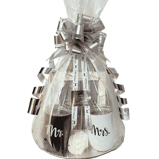 Happily Ever After engagement gift with bottle of champagne and glasses labeled 'Mr.' and 'Mrs.' in a decorative package.
