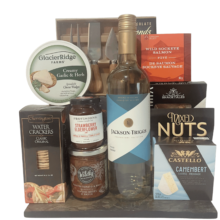 Assorted food and wine products including a bottle of Jackson-Triggs wine, cheese, crackers, and other snacks and a set of cheese knives on a slate serving platter.