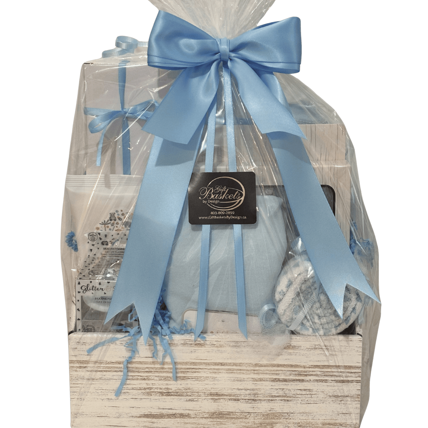Little Beginnings blue baby gift basket with clothing and baby essentials in a white ladder box with blue satin ribbon