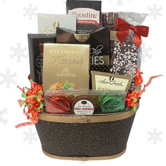 Holiday themed gift basket with various chocolate items including almonds, fudge, and truffles on a white background.