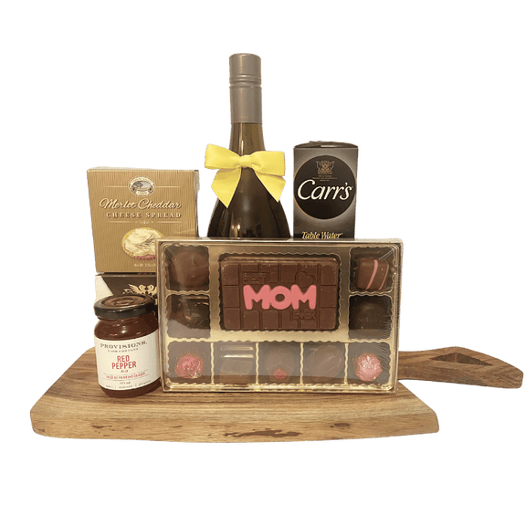 An elegant Mother’s Day cheese board gift featuring wine, brie, cheddar spread, red pepper jelly, crackers, and a “Best Mom Ever” chocolate box.