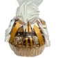 A beautifully wrapped sympathy gift basket with gold ribbons, a white bow, and cellophane.