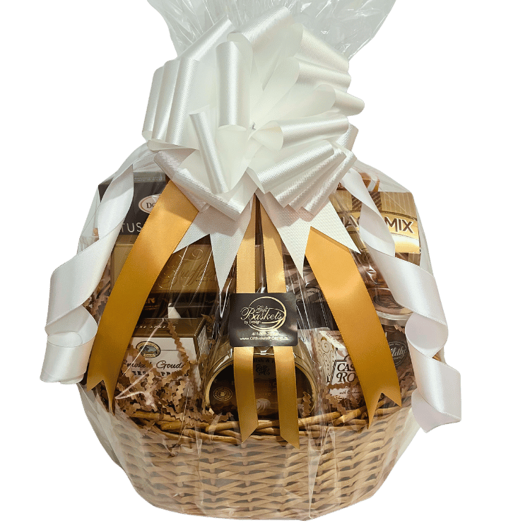 A beautifully wrapped sympathy gift basket with gold ribbons, a white bow, and cellophane.