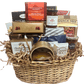 A golden wicker basket filled with gourmet treats, including cheese, crackers, chocolates, and tea