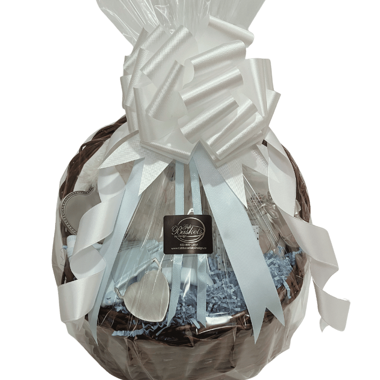 Blue version wrapped: Sparkle Eyes baby gift basket with blue ribbon, plush lamb, and baby keepsakes