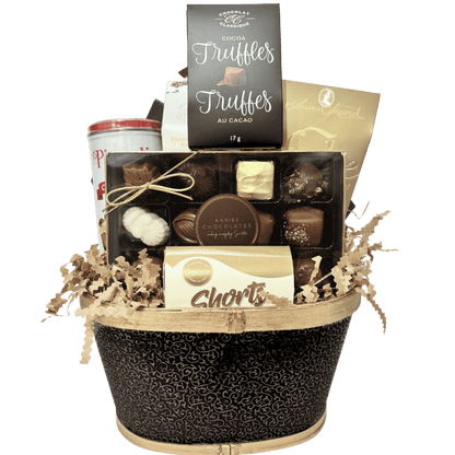 An elegant chocolate gift basket filled with premium boxed chocolates, gourmet truffles, chocolate wafers, buttery shortbread, handcrafted fudge, almond butter crunch, beautifully displaying contents unwrapped.