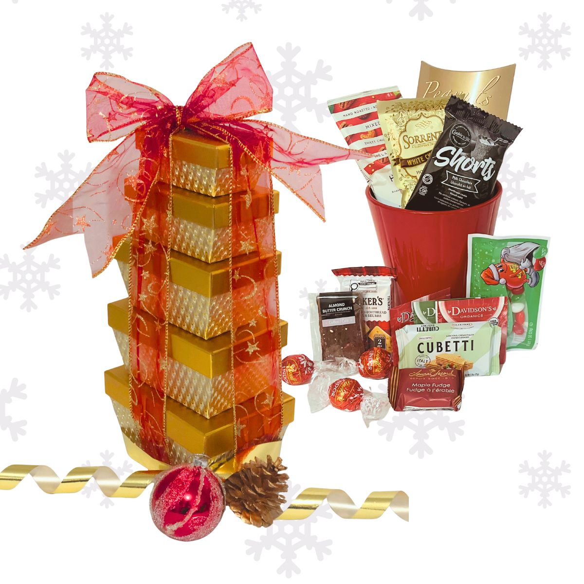 Holiday gold tower gift box tied with satin ribbon, filled with chocolates, cookies, tea, and festive gourmet treats