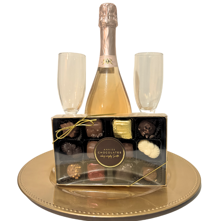 Pink and gold sparkling wine gift with artisan chocolates and keepsake champagne flutes