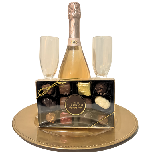 Pink and gold sparkling wine gift with artisan chocolates and keepsake champagne flutes