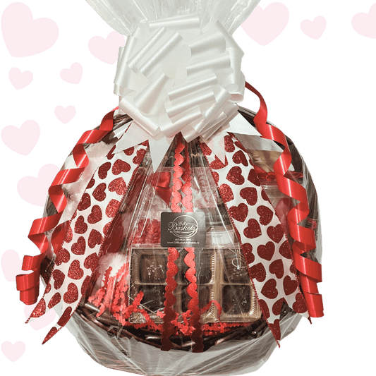 Timeless Romantic Valentine’s Day gift basket with plush teddy bear, artisan chocolates, caramel popcorn, Turkish delight, spa bath soak, candle, and romantic wine glass, wrapped with heart ribbons.