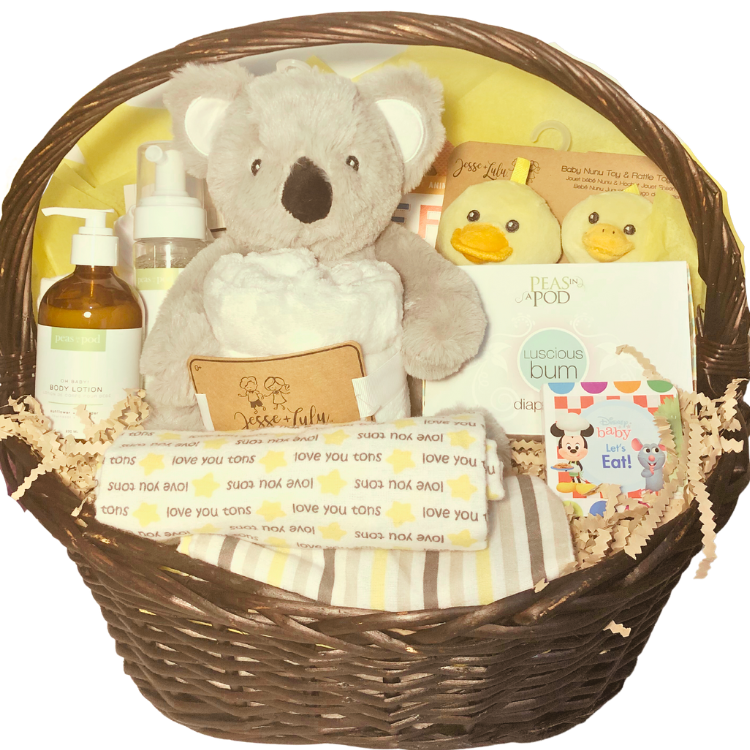 Ultimate baby gift basket with blankets, baby clothes, books, toys, and locally made bath care products, ideal for gifting in Calgary