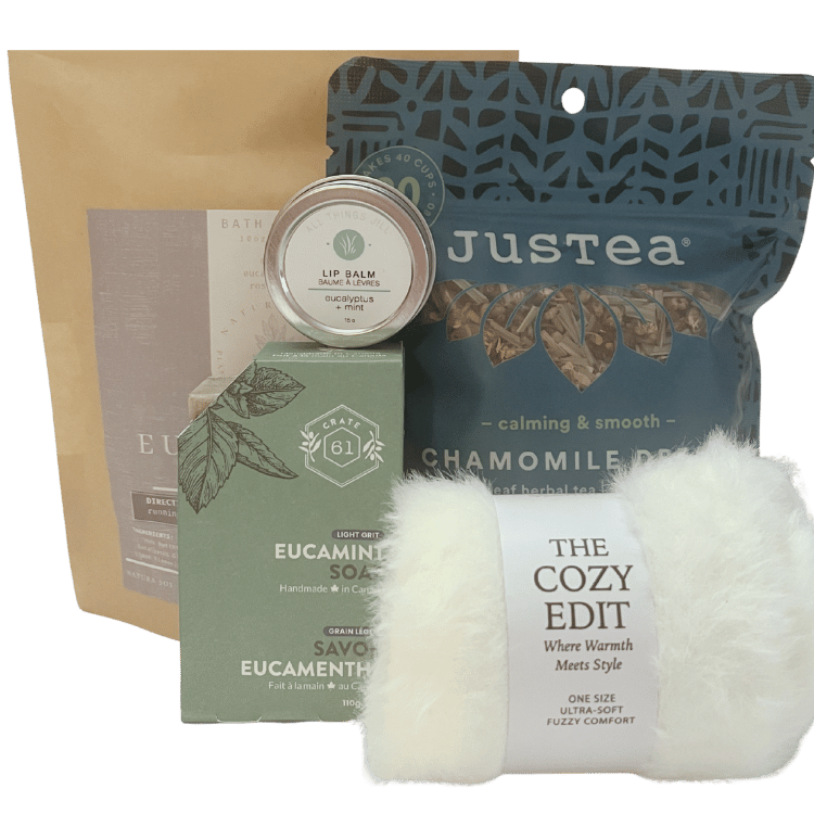 Signature Collection of wellness and self-care products including a lip balm, soap, and chamomile tea with a cozy blanket.