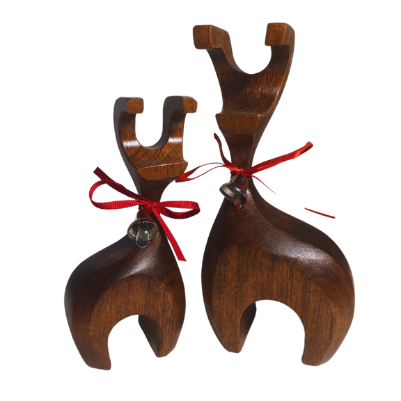 Handcrafted wooden reindeer with decorative bell, made from reclaimed oak, cherry, walnut, and maple hardwoods, finished with a walnut stain and protective lacquer, displayed on a cream background.